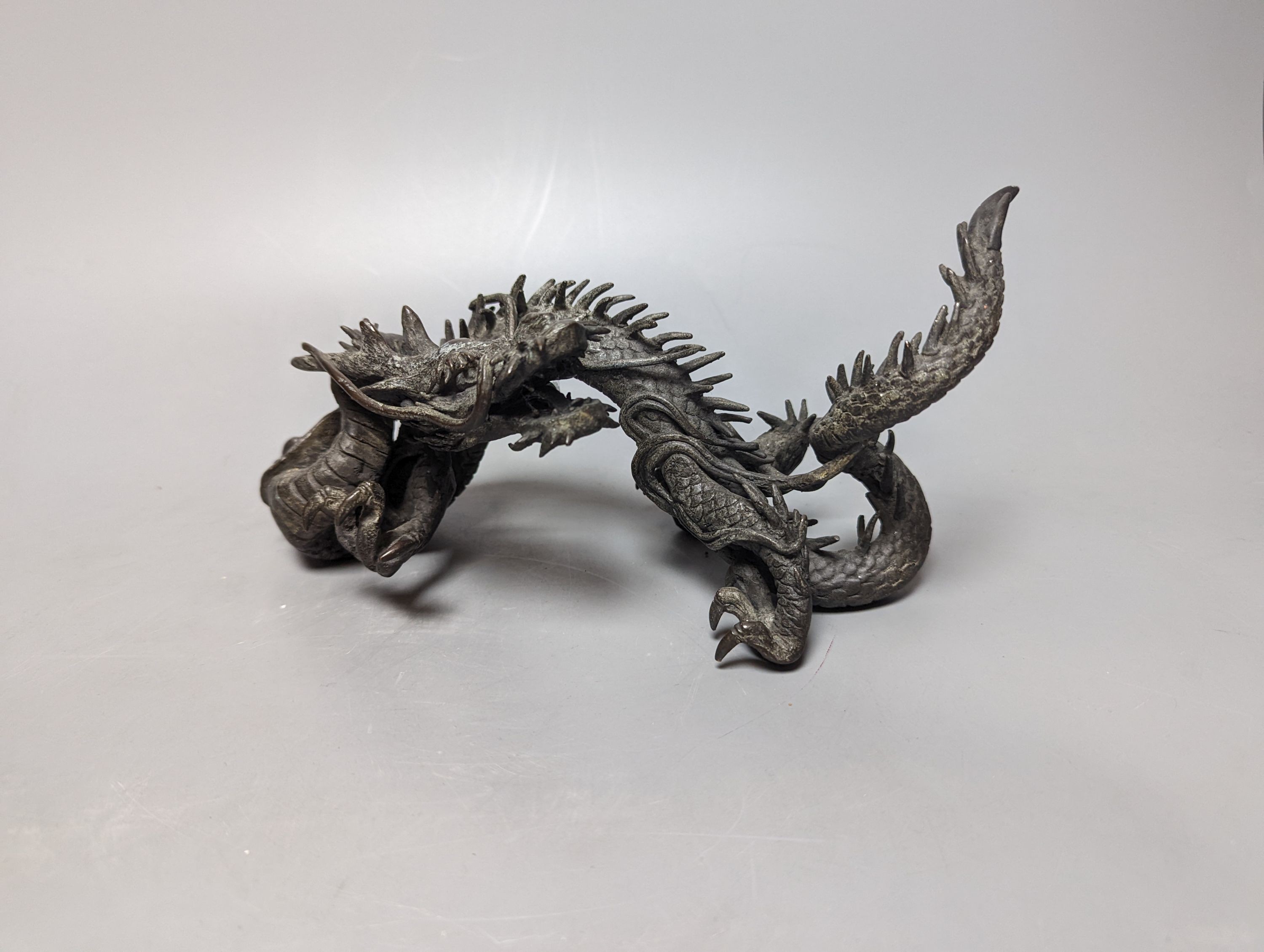 A pair of early 20th century Japanese bronze figures of dragons 22cm